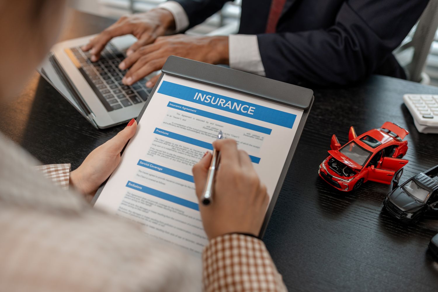 woman signing car insurance contract